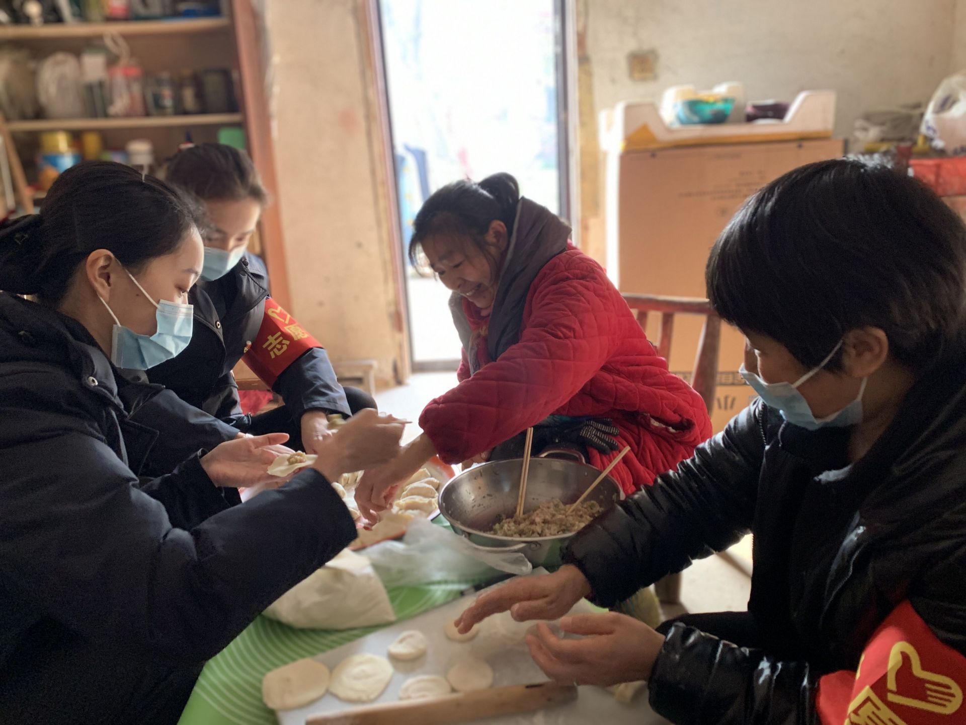志愿者围坐在一起，包饺子庆团圆 刘珍珍 摄.jpg.jpg