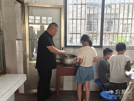王老师为学生打饭.jpg