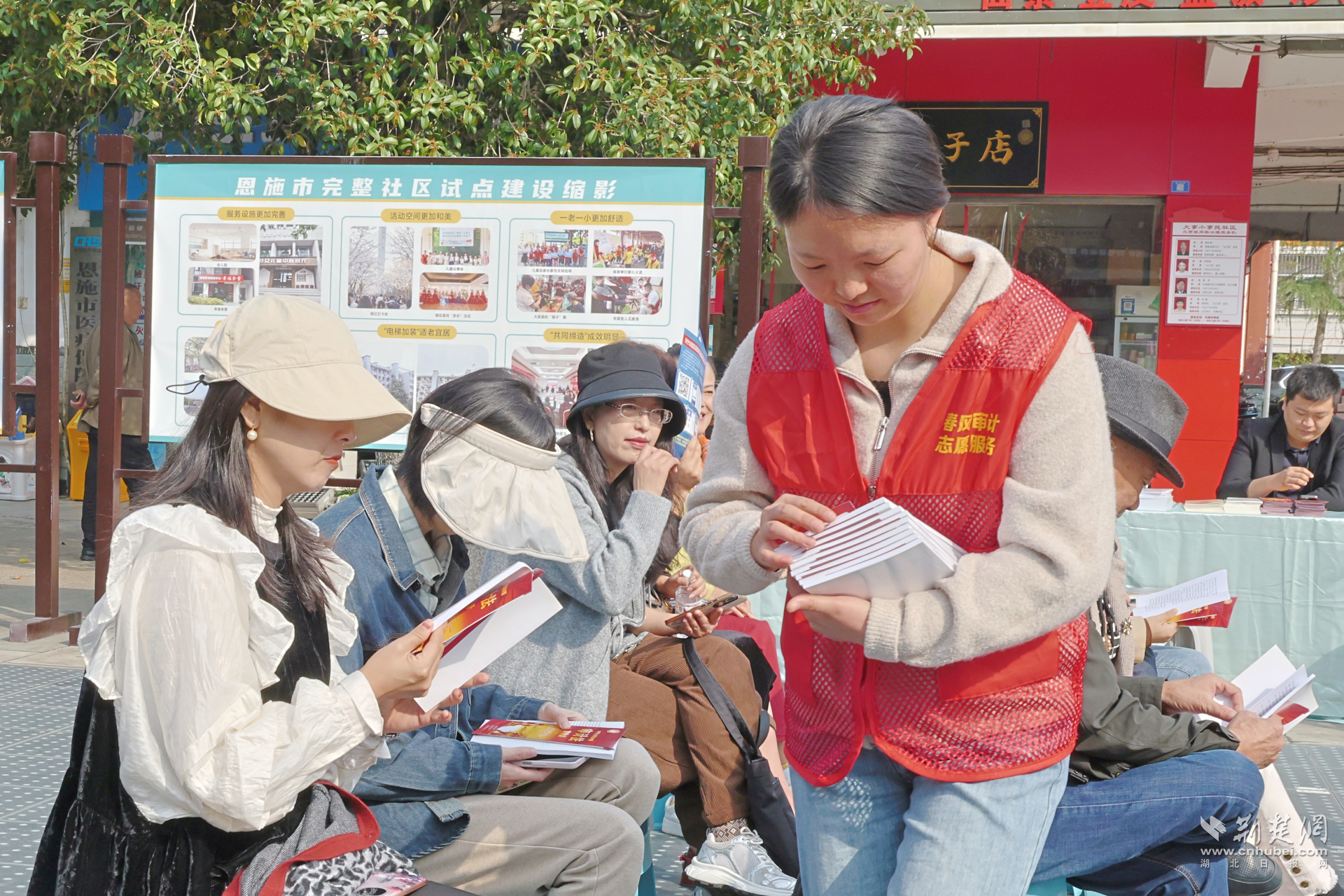 工作人员为市民发放宣传册.png.png